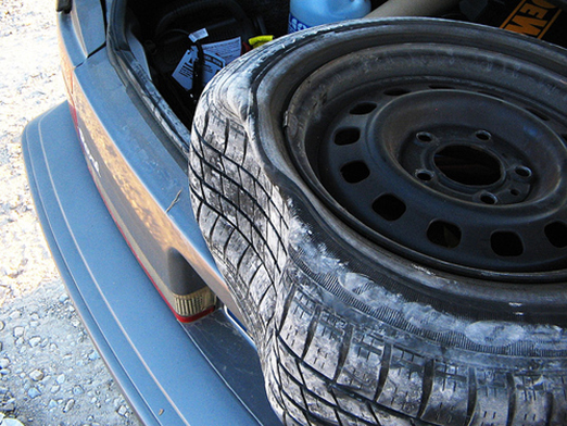 flat tire in the trunk of a car