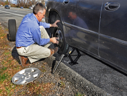 placing the spare tire on the car