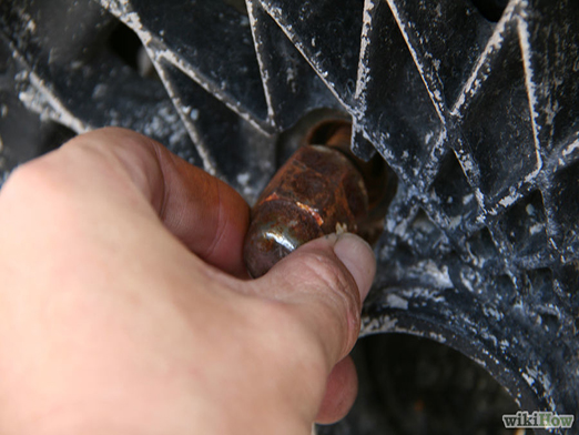 removing the lug nuts from a car